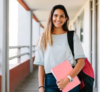 girl holding notebook and backpack