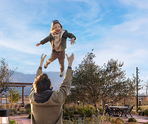 dad throws toddler into the air