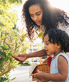 mother and daughter picking berries