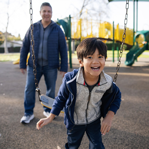 young child on swingset